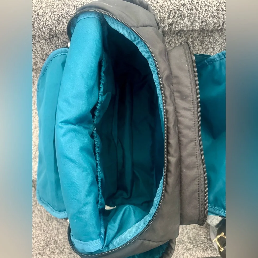 Skip Hop Forma Diaper Backpack. Black Exterior with Teal Interior.